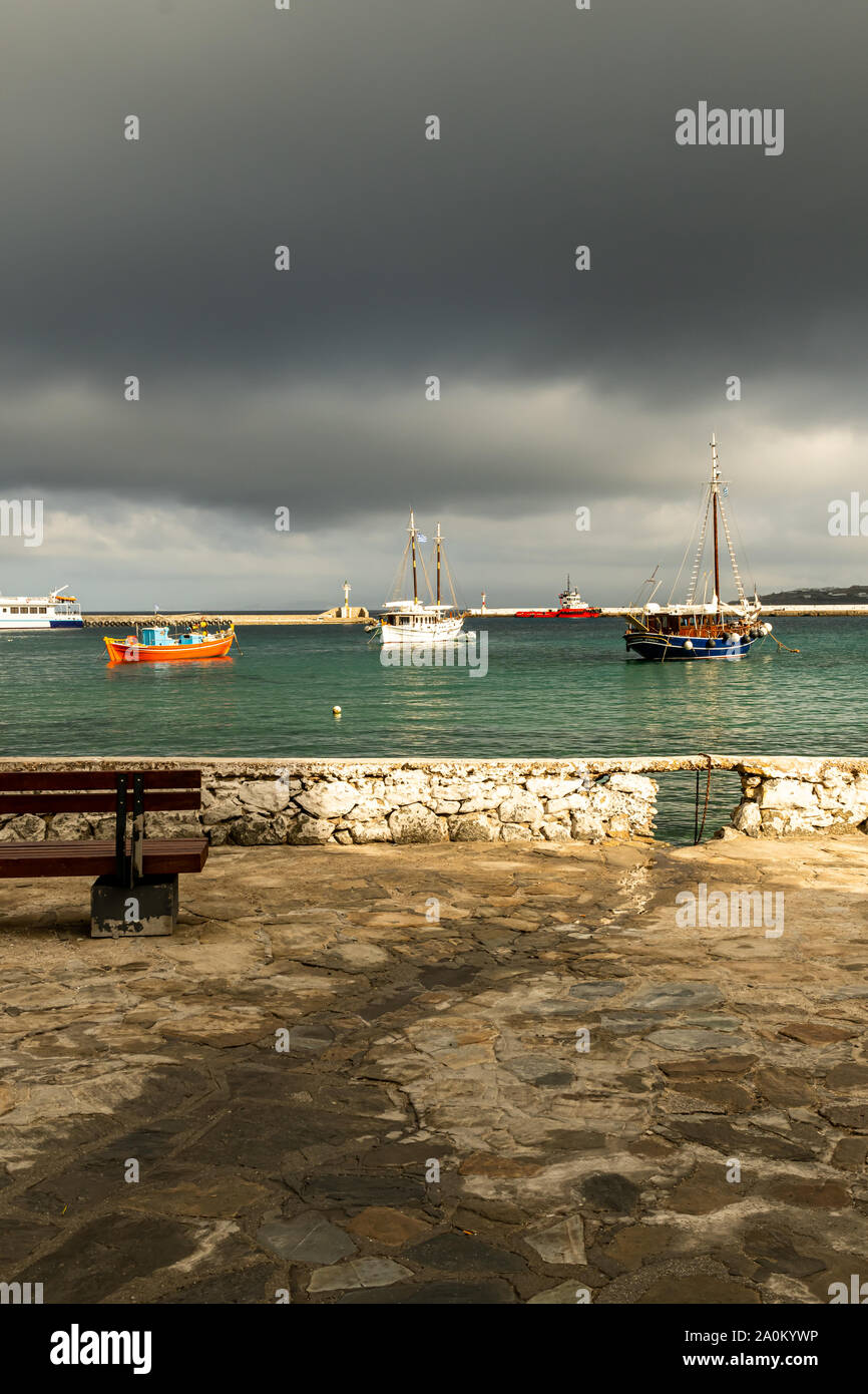 Looking out to sea from the Mykonos harbor shoreline on a stormy day Stock Photo