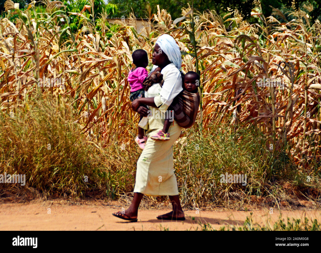 Mombasa / Kenya, Africa - 25 January, 2018: African woman walking with children in the village near Mombasa. Stock Photo
