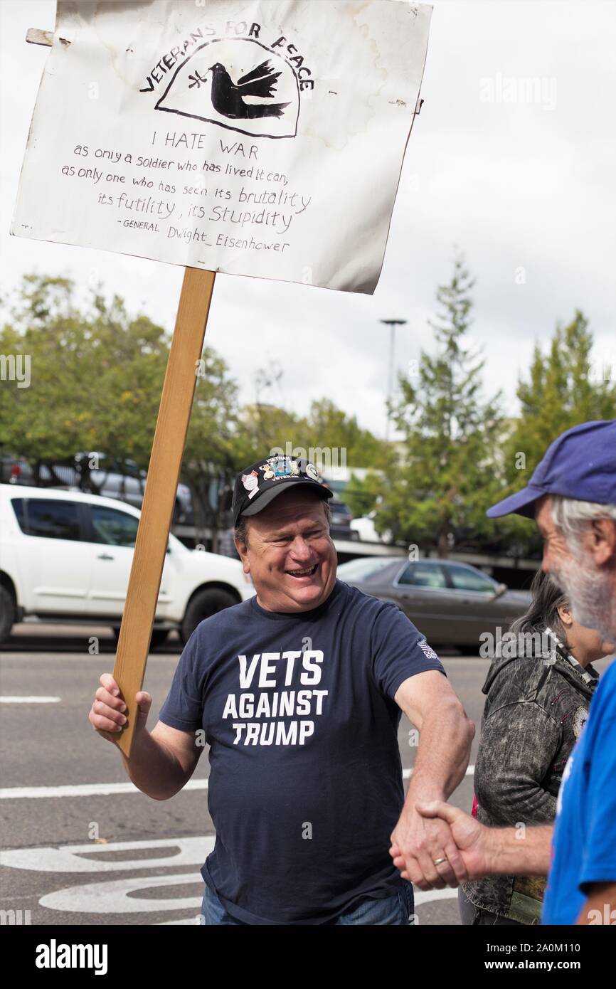 A man wearing a 'Vets Against Trump' t-shirt and carrying a sign, at the Climate Strike rally in Eugene, Oregon, USA. Stock Photo