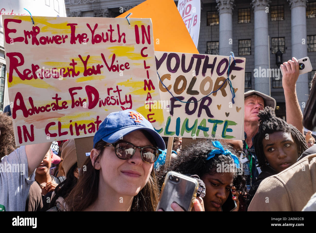 New York, USA. 20th Sep 2019.  Thousands of students as well as adults gathered in New York for the Global Climate Strike, meeting in Foley Square near the Federal Government buildings and New York's City Hall, and marching downtown to Battery Park, where Swedish climate activist and spokesperson Greta Thunberg addressed the crowd. Two signs read 'Empower the youth / represent your voice / advocate for diversity / in climate,' and 'Youth of color for climate.' Credit: Ed Lefkowicz/Alamy Live News Stock Photo