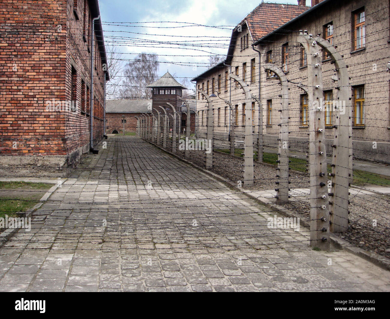 Electric fencing surrounds building at the Auswitz Concentration Camp Stock Photo