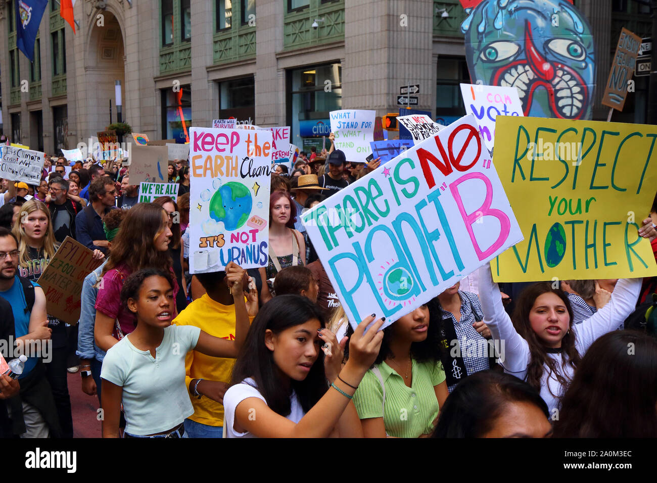 New York, NY. September 20, 2019. Young women hold signs 'There is No Planet B' and 'Respect Your Mother' at the youth-led NYC Climate Strike. Tens of thousands of people, students attended the march and rally down Broadway to Battery Park with Greta Thunberg as a participant and featured guest. Stock Photo