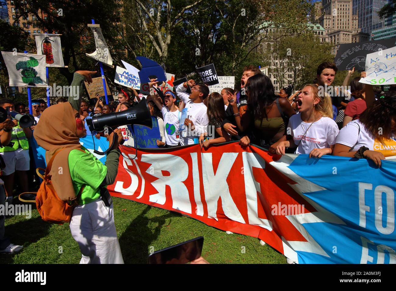 New York, NY. September 20, 2019. A diverse group of young people yell in support of the climate at the NYC Climate Strike. Tens of thousands of people, students attended the march and rally down Broadway to Battery Park with Greta Thunberg as a participant and featured guest. Stock Photo