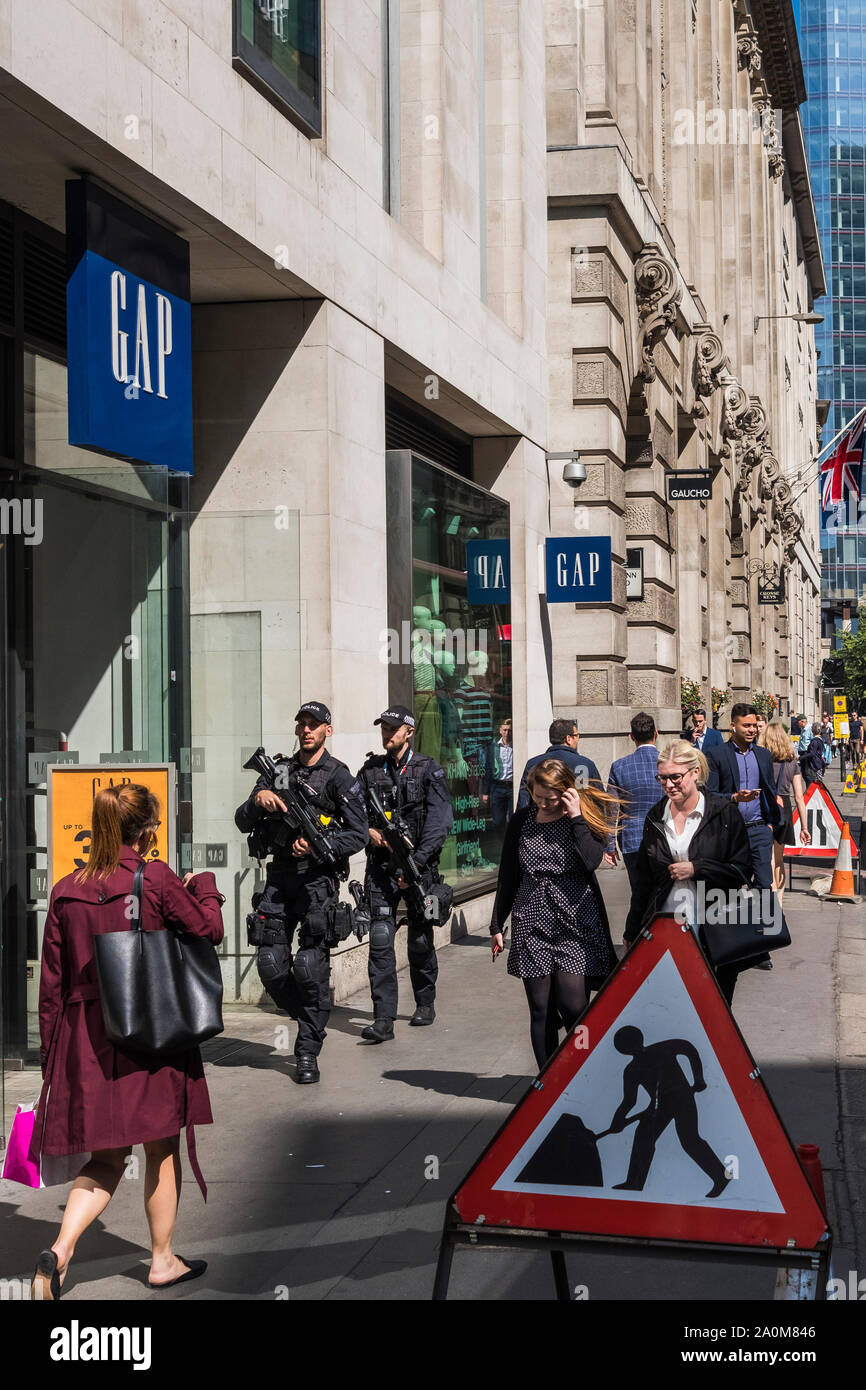 Armed police patrol the streets of the capital, City of London, England , U.K. Stock Photo