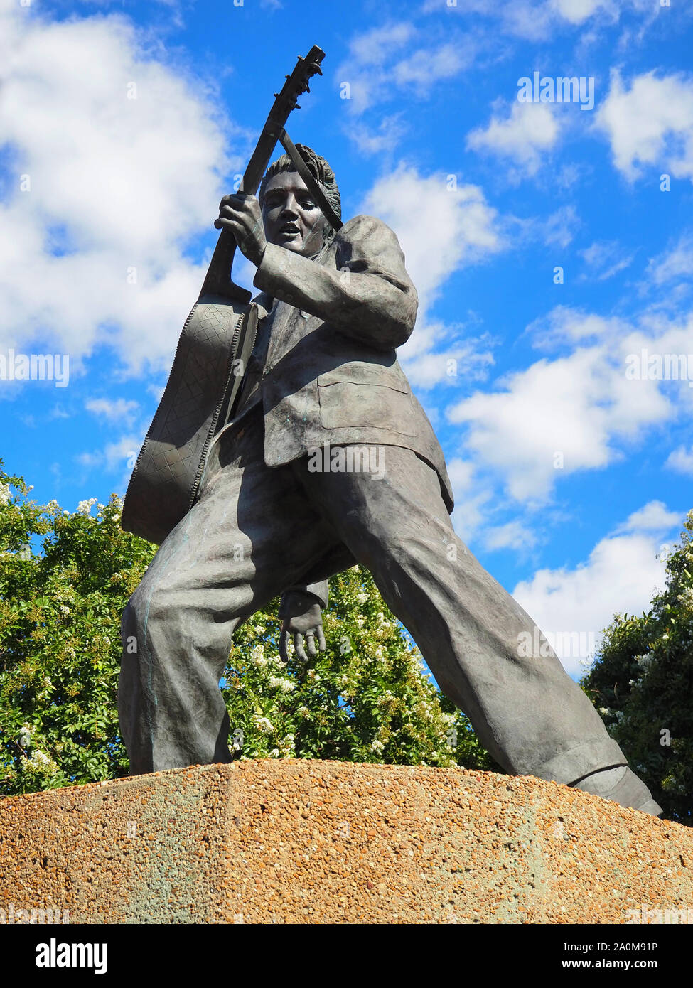 MEMPHIS, TENNESEE - JULY 23, 2019: A bronze statue of Elvis Presley playing his guitar, erected by scuptor Andrea Lugar in 1997, depicts the musician Stock Photo