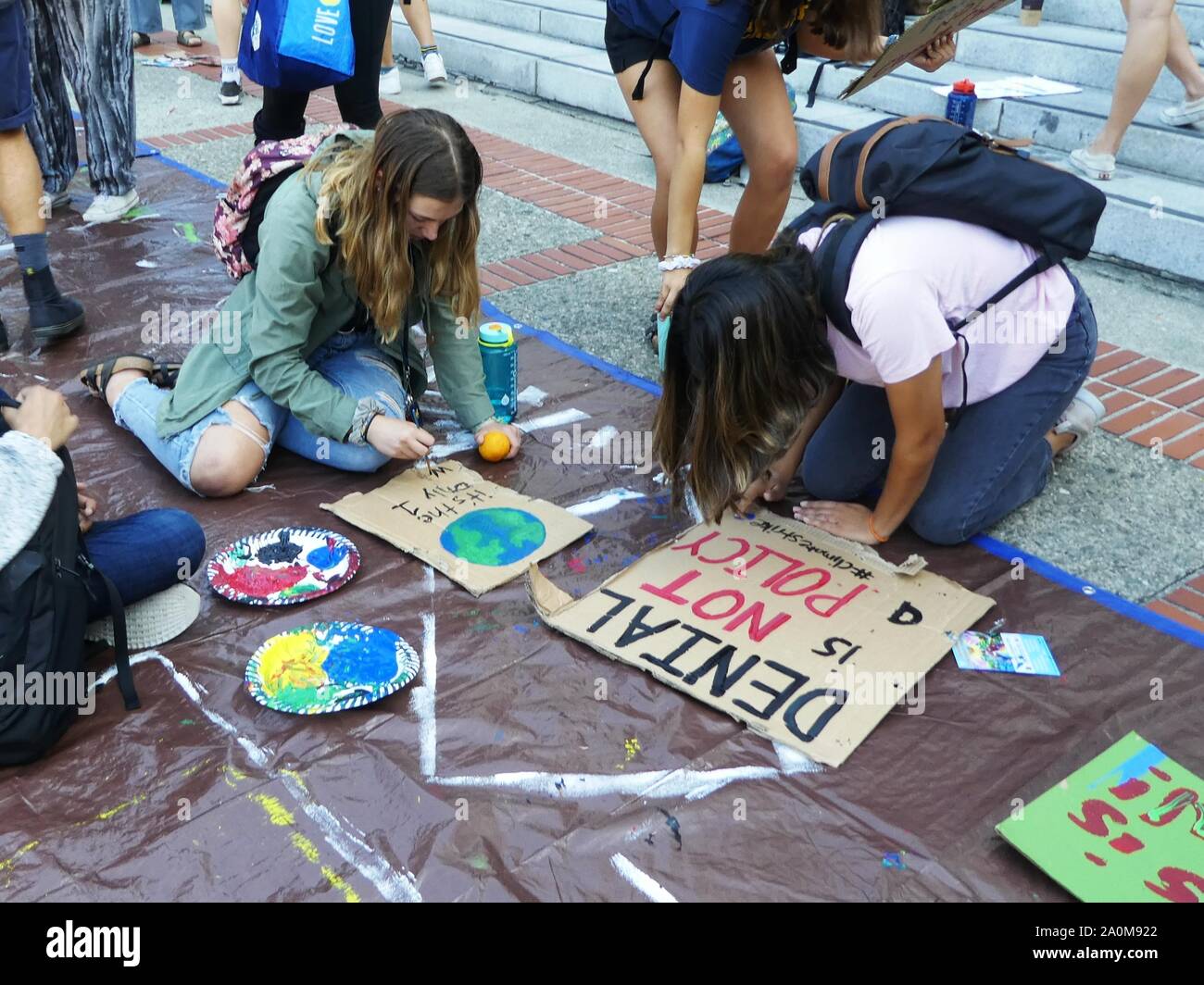 Young students make hand-made signs to protest lack of action on the climate crisis Stock Photo