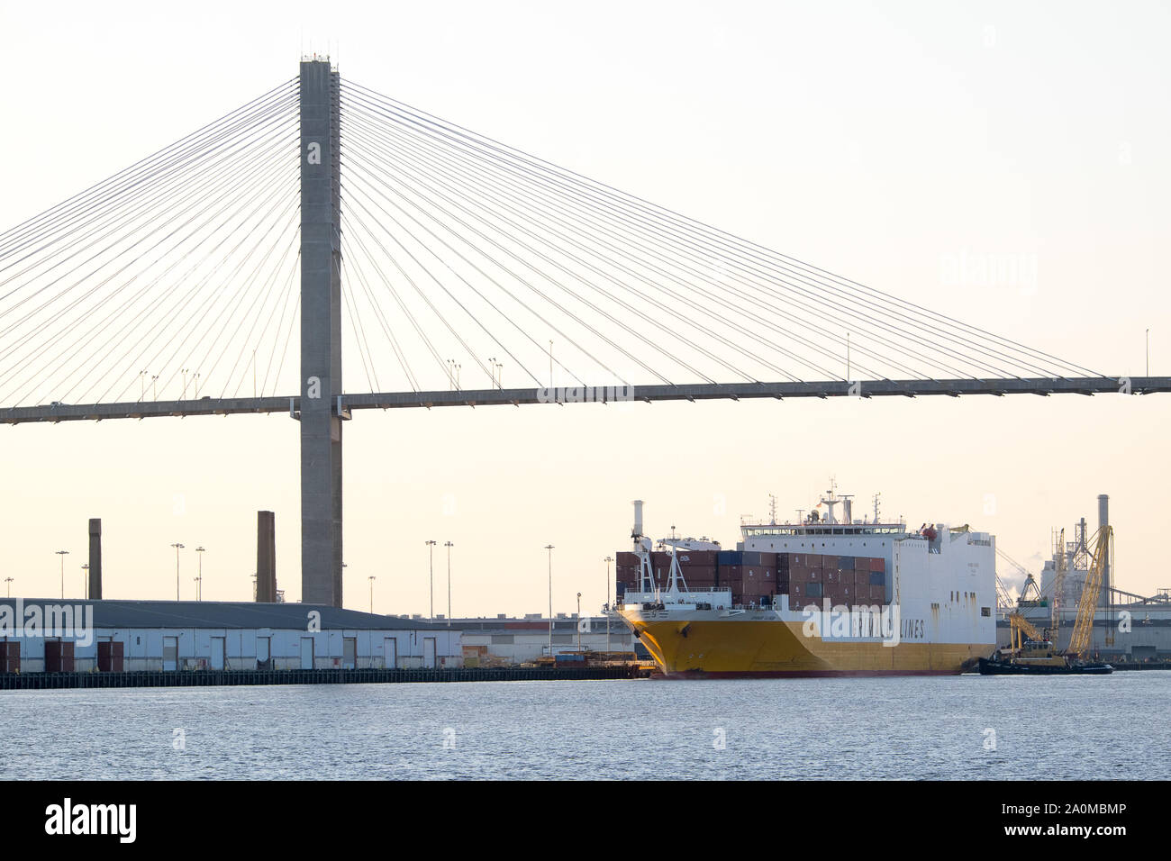 A large ocean vessel departs from the port of Savannah, GA as it navigates the Savannah River towards the Atlantic. Stock Photo