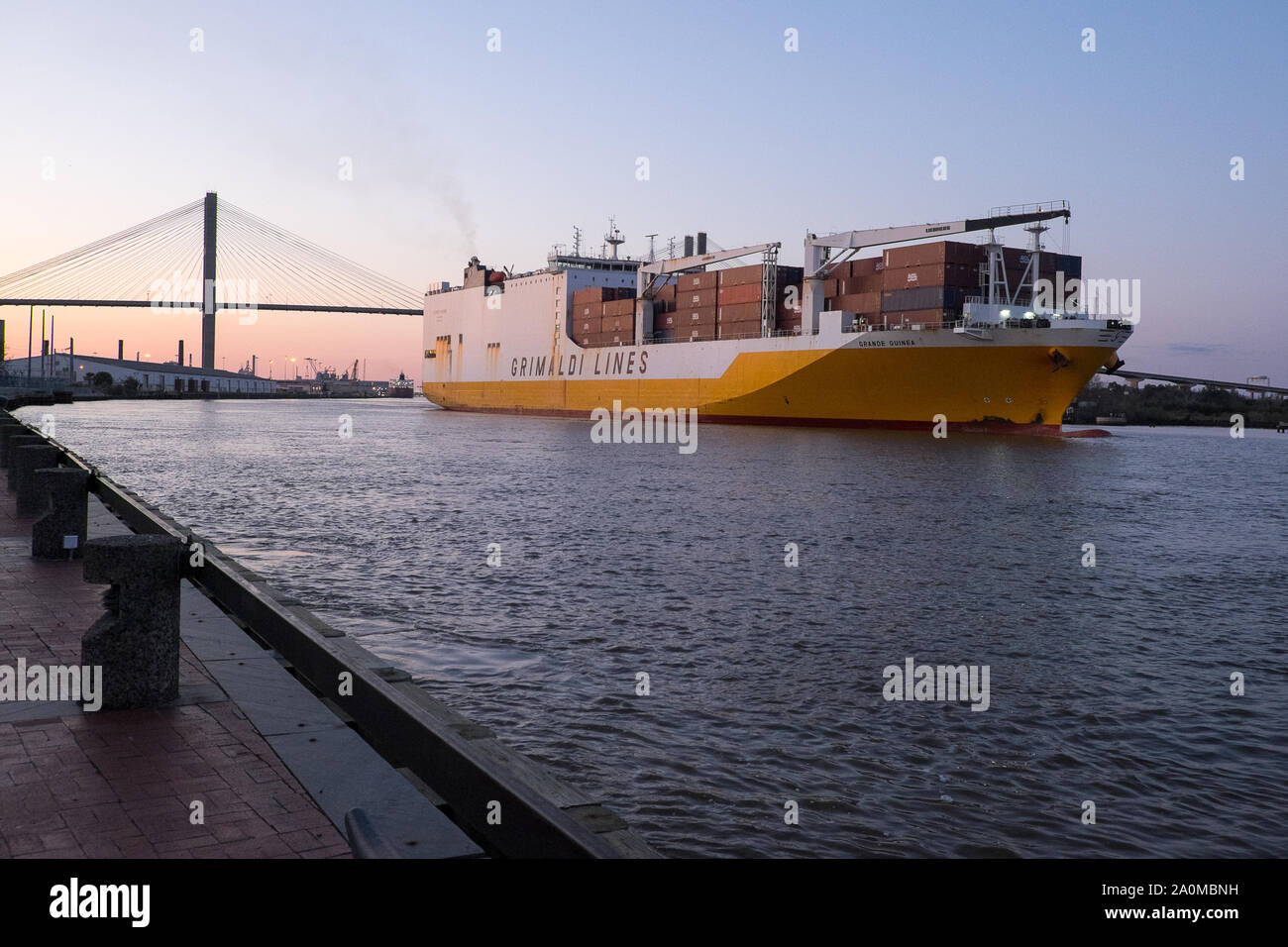 A large ocean vessel departs from the port of Savannah, GA as it navigates the Savannah River towards the Atlantic. Stock Photo
