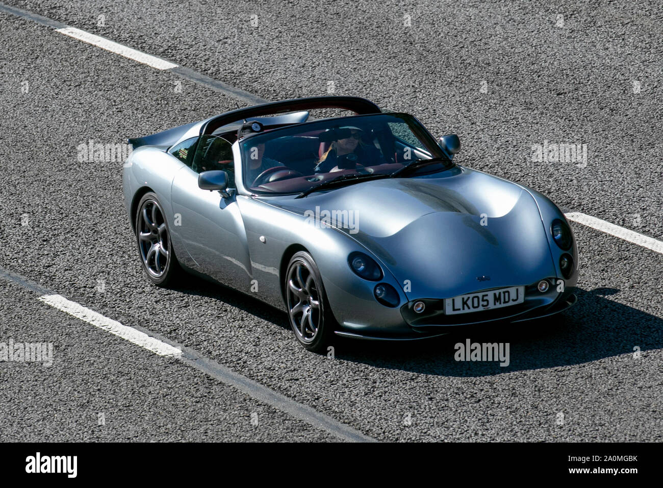 2005 Blue TVR Tuscan S lightweight sports cars,  powerful engines, British hand built, open sport; UK Vehicular traffic, transport, modern, saloon cars, south-bound on the 3 lane M6 motorway highway. Stock Photo