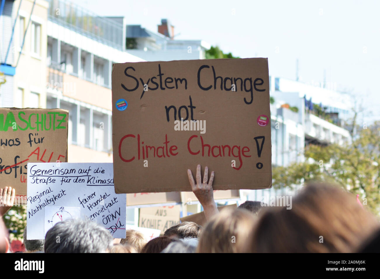 Heidelberg, Germany  20th September 2019:  Protest sign saying 'Systemc hange not climate change' held up by young people during Global Climate Strike Stock Photo