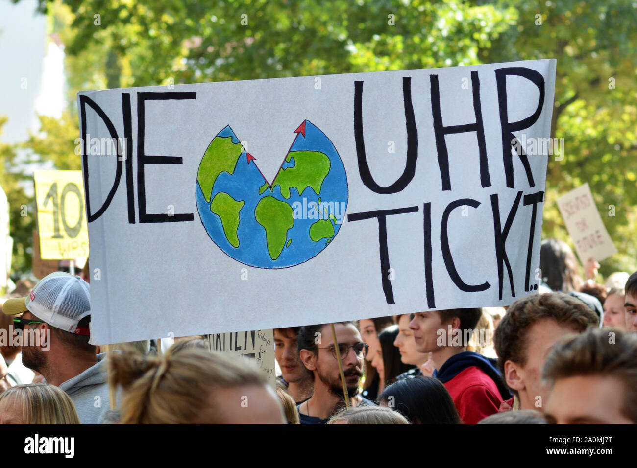 Protest sign saying 'Time is ticking' in German held up by young people during Global Climate Strike Stock Photo