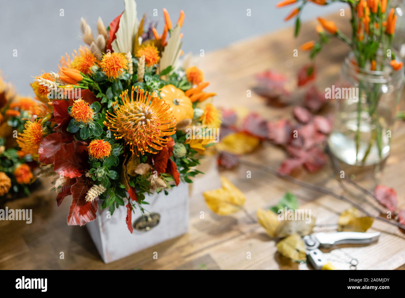 Process Of Creating Autumn Bouquet Of Mixed Flowers On Wooden Table. The  Work Of The Florist At A Flower Shop. Fresh Cut Flower Stock Photo - Alamy