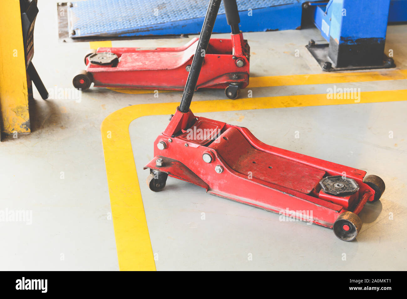 Hydraulic jack for lifting up car and vehicle in repairing garage workshop  service center. Tool and equipment of automotive concept Stock Photo - Alamy