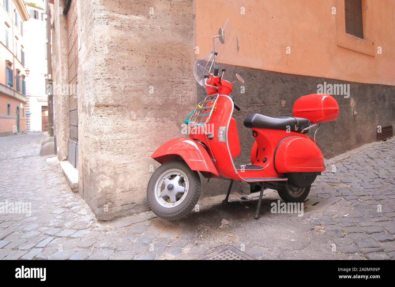 Red scooter alleyway cityscape Rome Italy Stock Photo