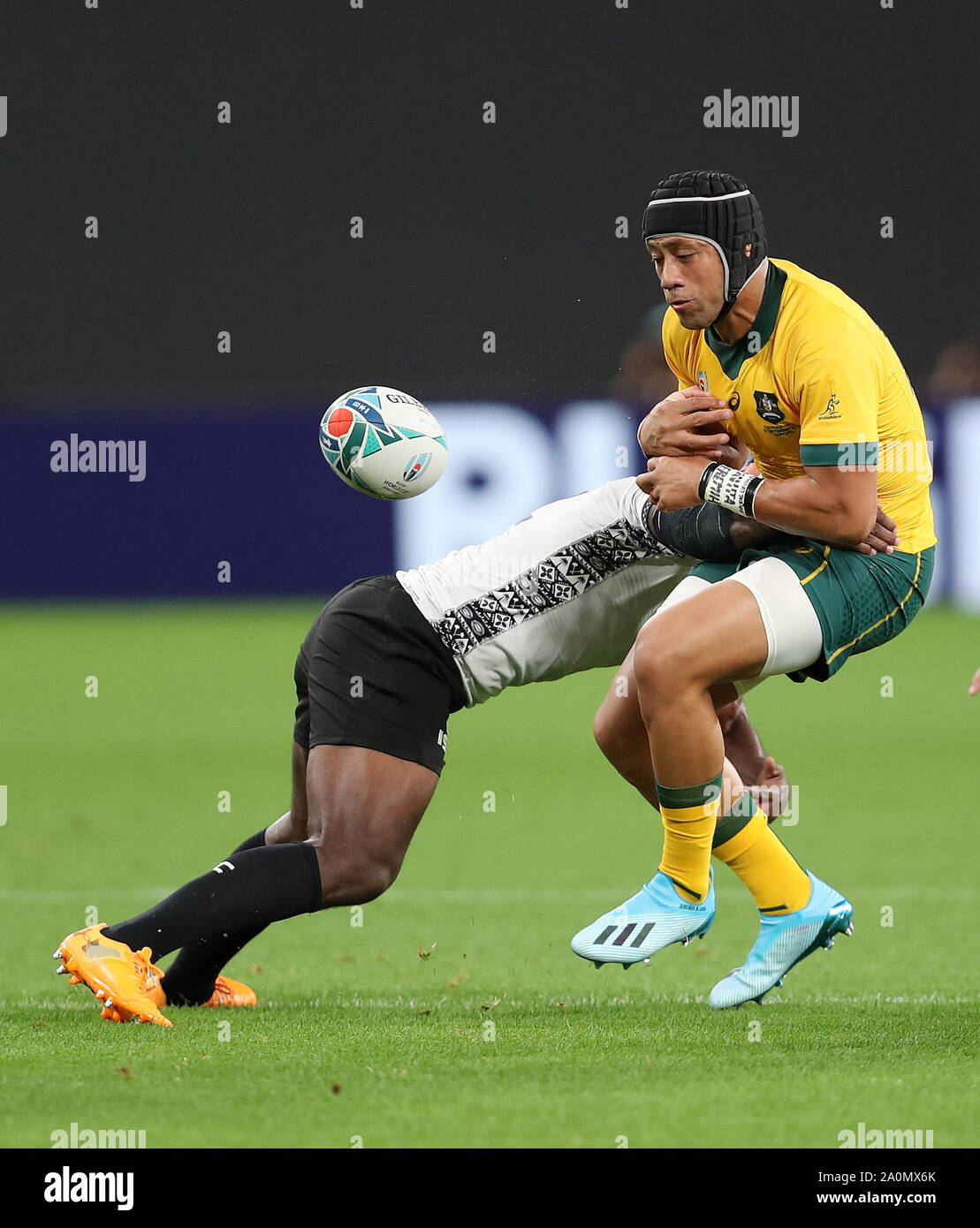 Australia's Christian Lealiifano is tackled by Fiji's Levani Botia during the 2019 Rugby World Cup Pool D match at Sapporo Dome. Stock Photo