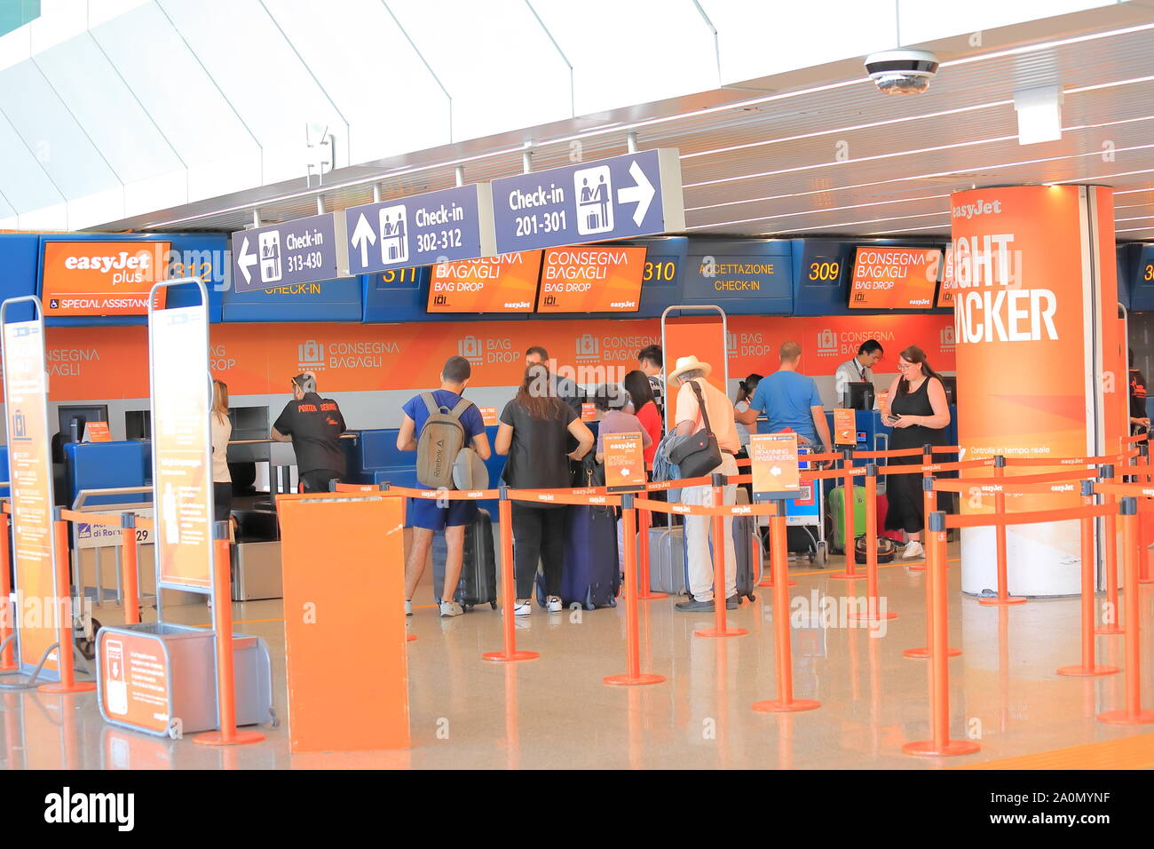 People check in at Easyjet check in counter Leonardo da Vinci-Fiumicino Airport Rome Italy Stock Photo
