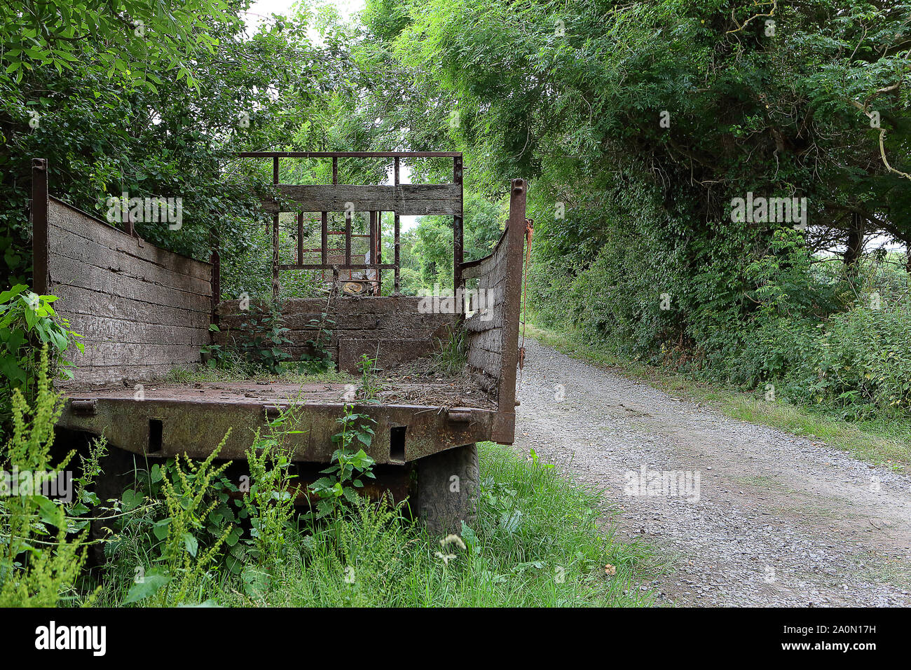 Old hay trailer in country lane Stock Photo