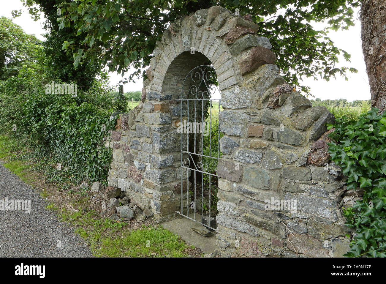 Stone wall with arch Stock Photo