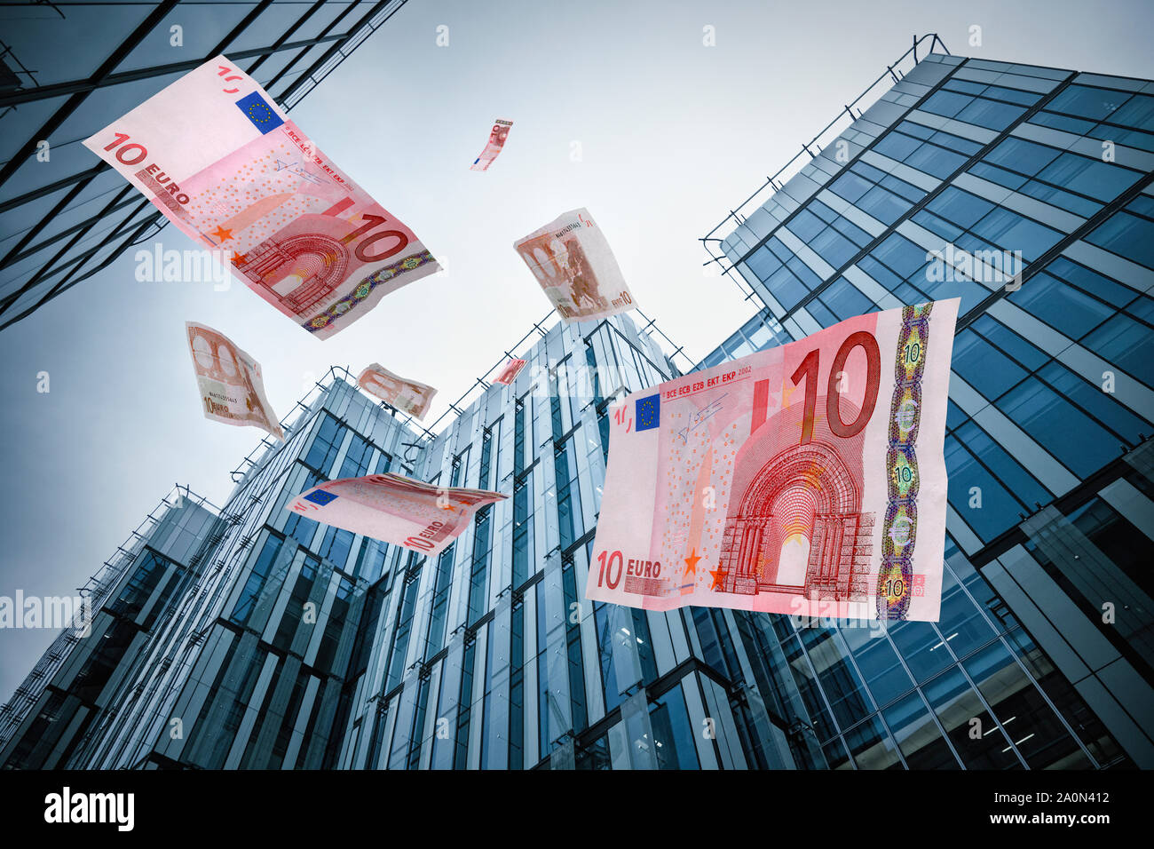 Euros falling from corporate city office buildings skyscrapers Stock Photo