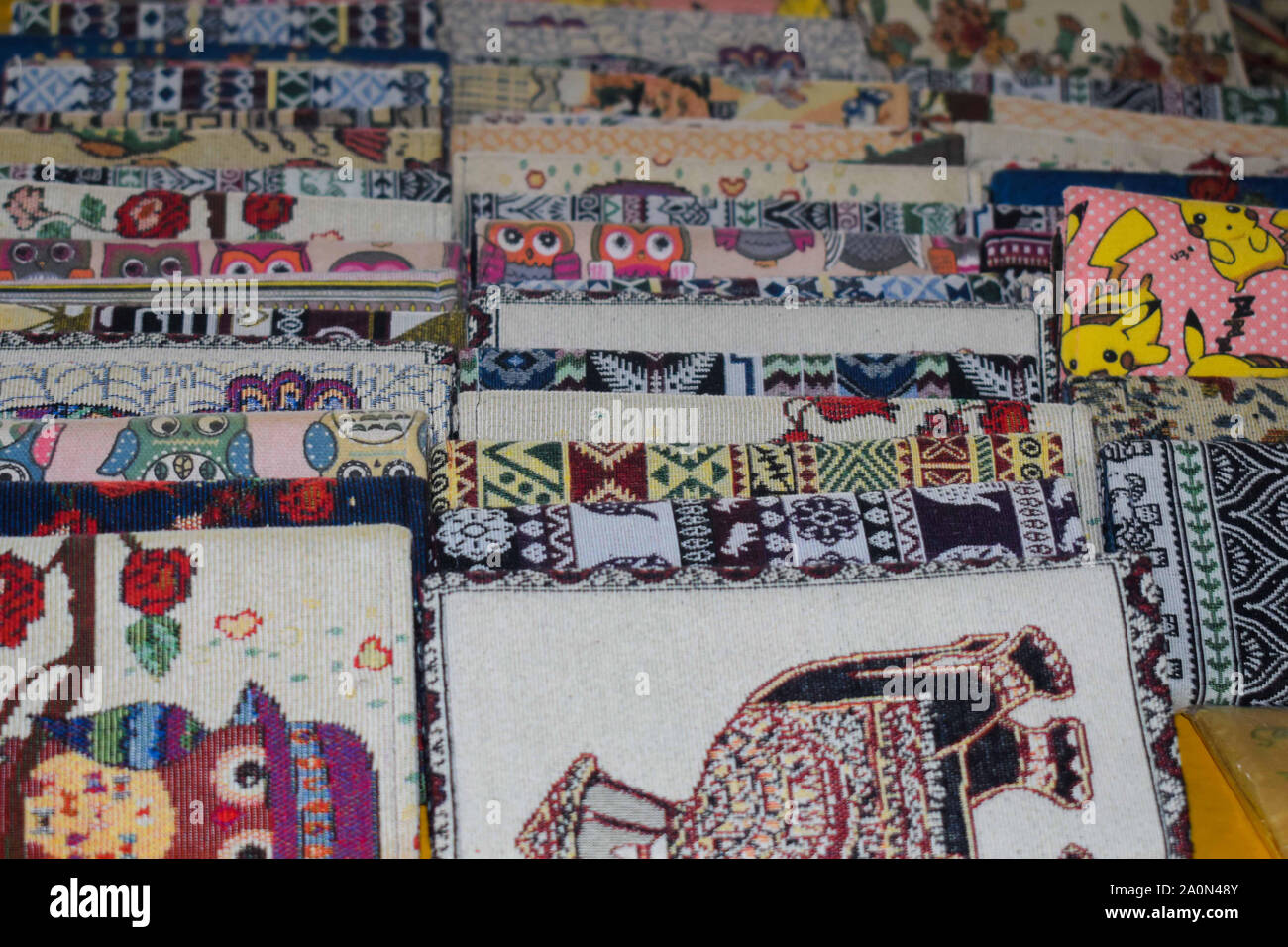 JULY 18, 2019-MEKONG DELTA, VIETNAM : Printed purses laid neatly on the table. Sold at a shop in Mekong Delta as a souvenir for tourist passing by. Stock Photo