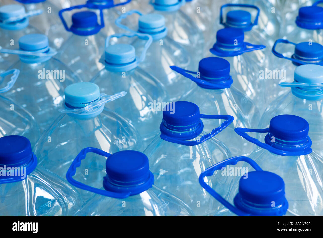 Empty plastic bottles in a rows. Plastic pollution Stock Photo