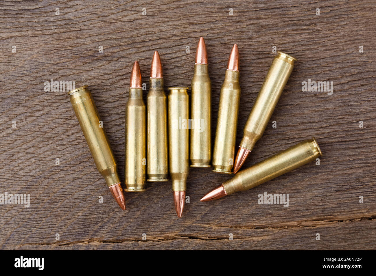Bullets on rustic wooden background close up. Stock Photo