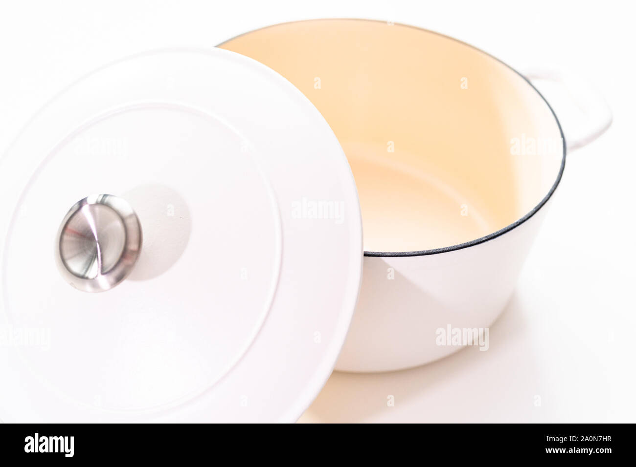 White enameled cast iron covered round dutch oven on a whjite background. Stock Photo