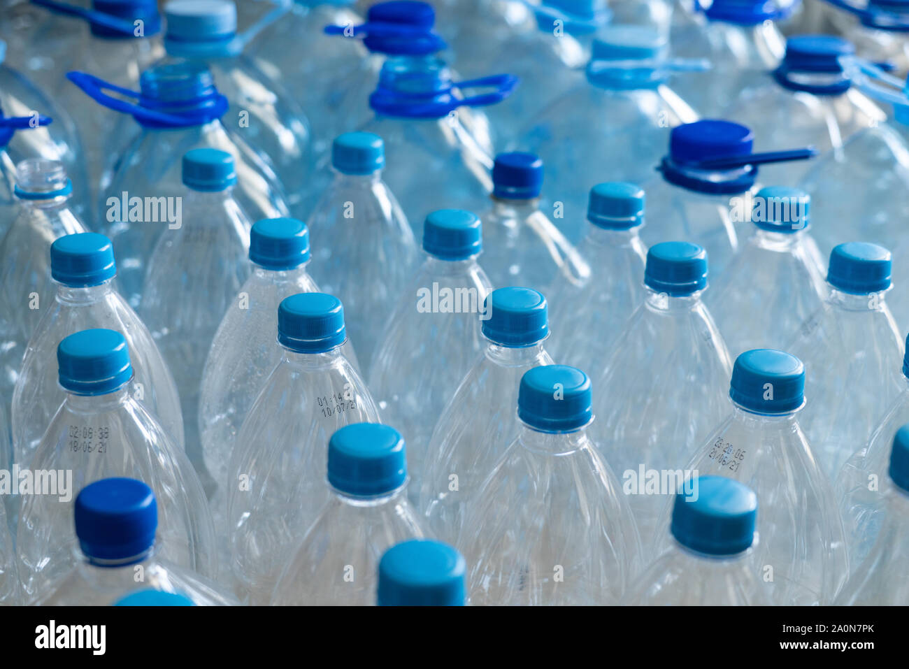 Empty plastic bottles in a rows. Plastic pollution Stock Photo