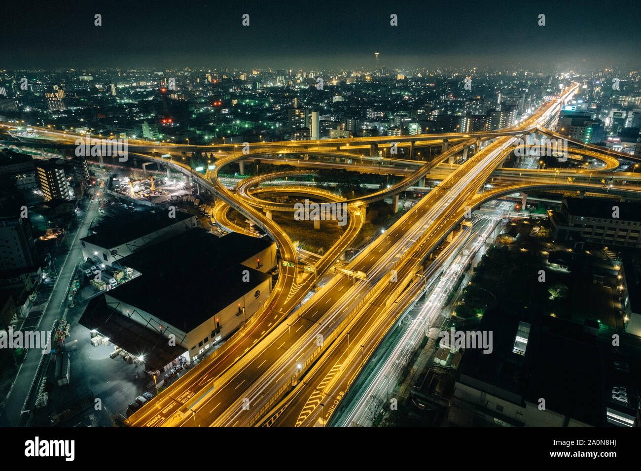 The amazing night view of highway in Osaka, expressway enter the city, night light picture on top view Stock Photo