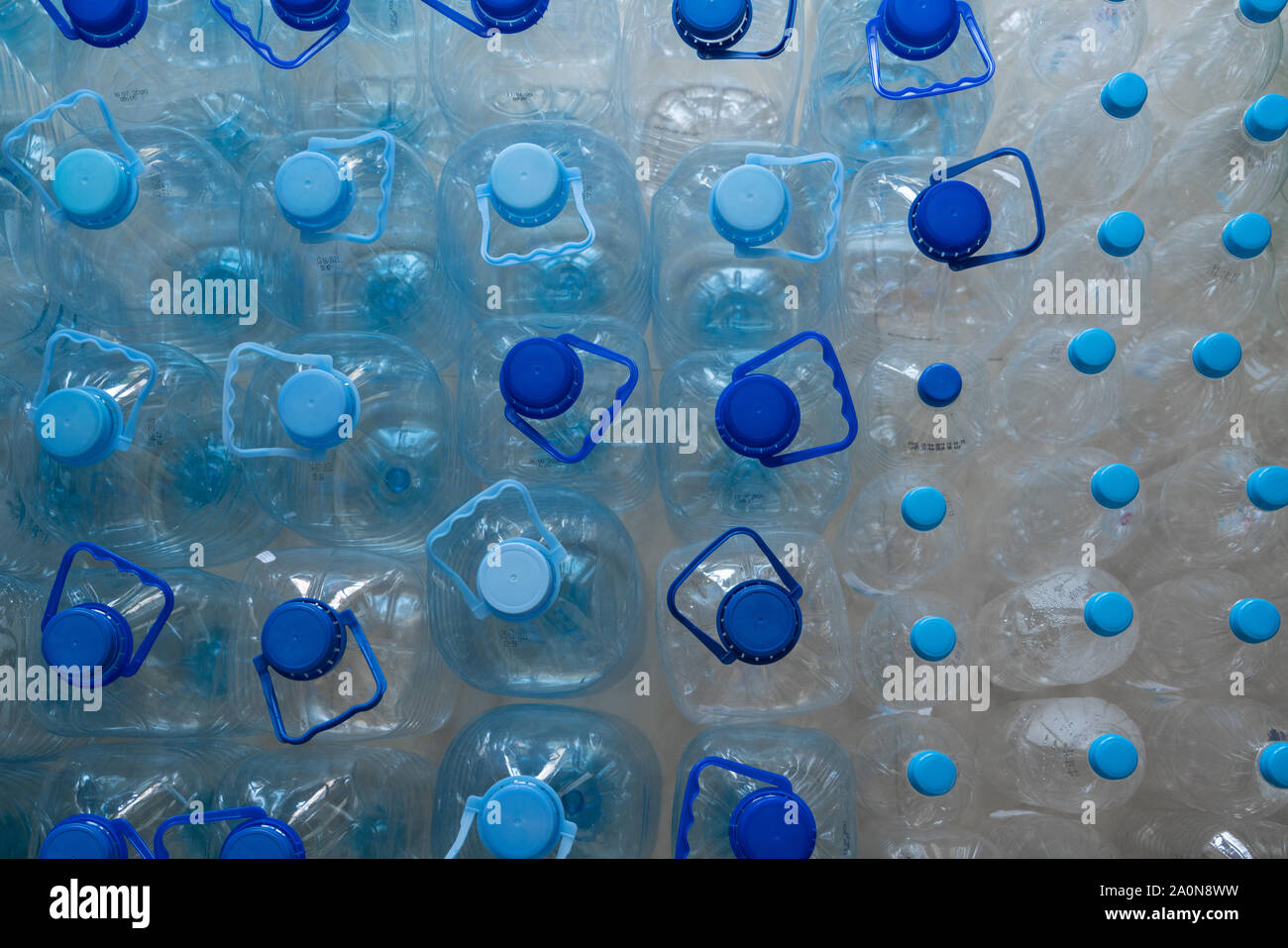Empty plastic bottles in a rows. Plastic pollution Stock Photo