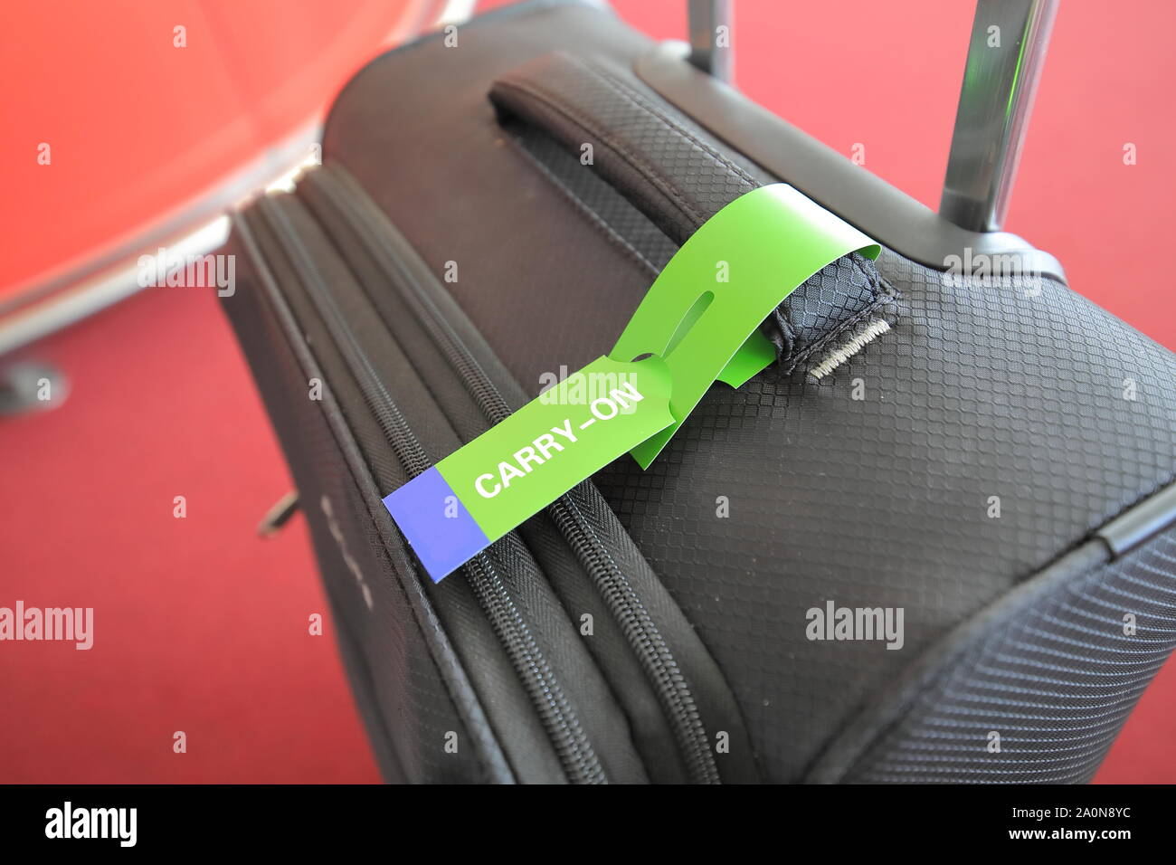 Carry on luggage tag on Suitcase Stock Photo Alamy
