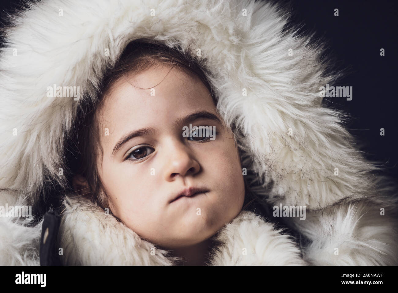 Close up portrait of a young girl dressed with an eskimo jacket  looking at the camera Stock Photo