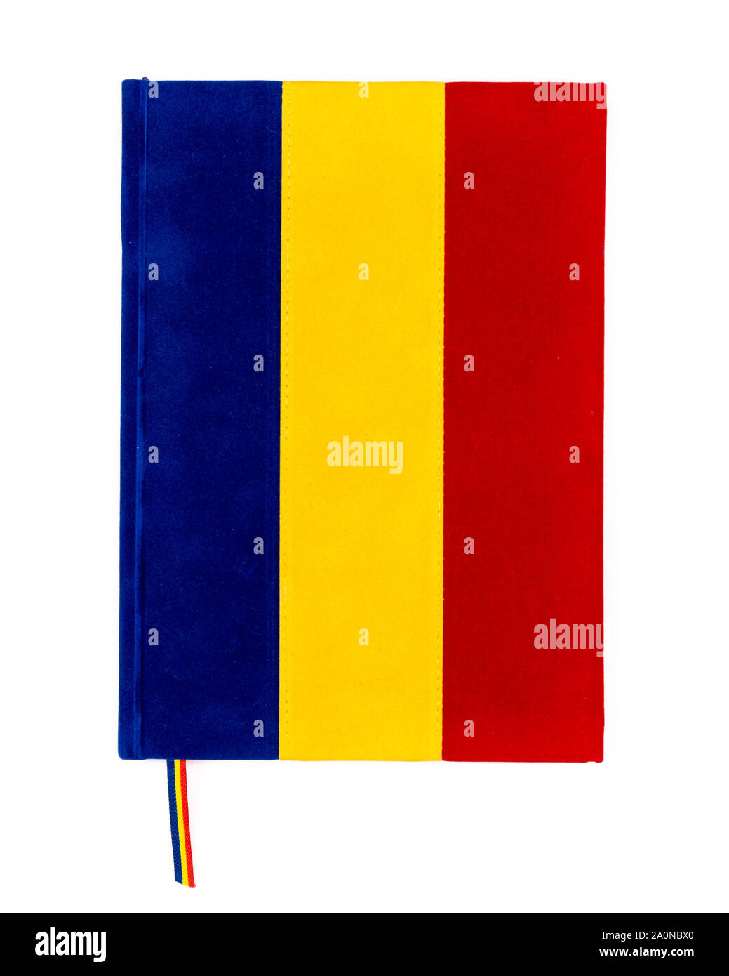 Blue, yellow, and red tricolor notebook representing Romanian flag isolated on white. Stock Photo