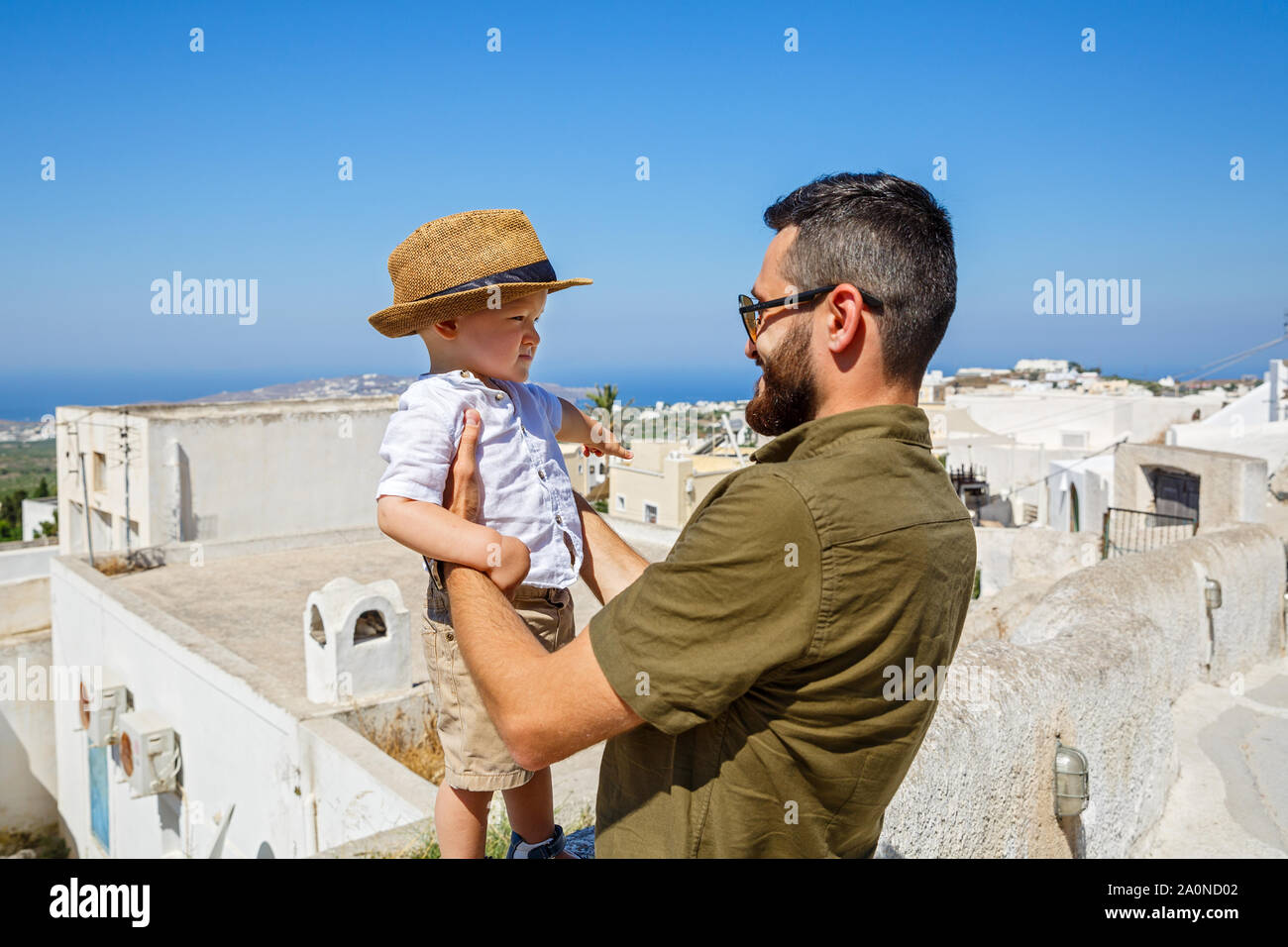 Father and little son walking on the island of Santorini Stock Photo