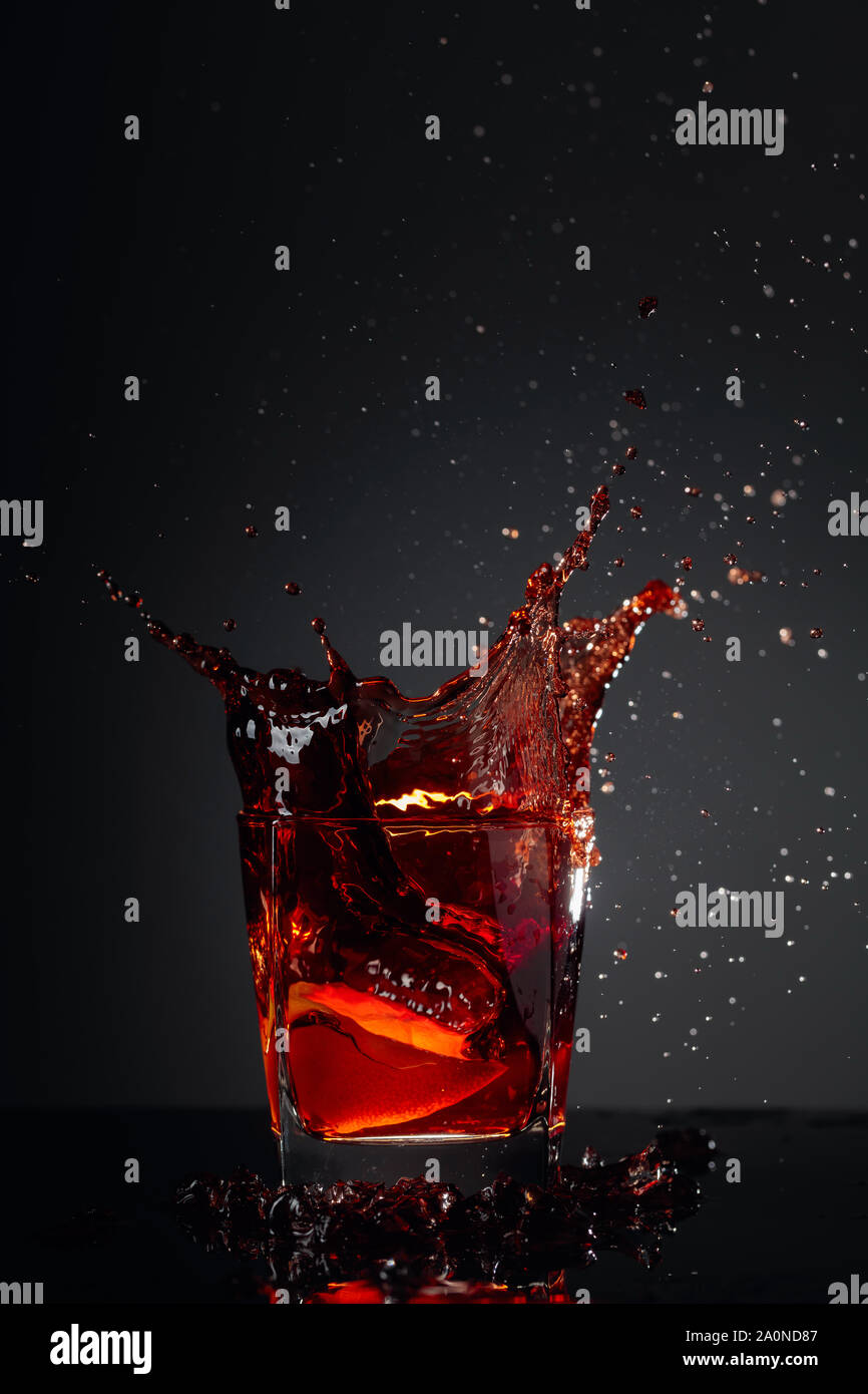 Cola glass with lemon and falling ice cubes on a dark background Stock ...