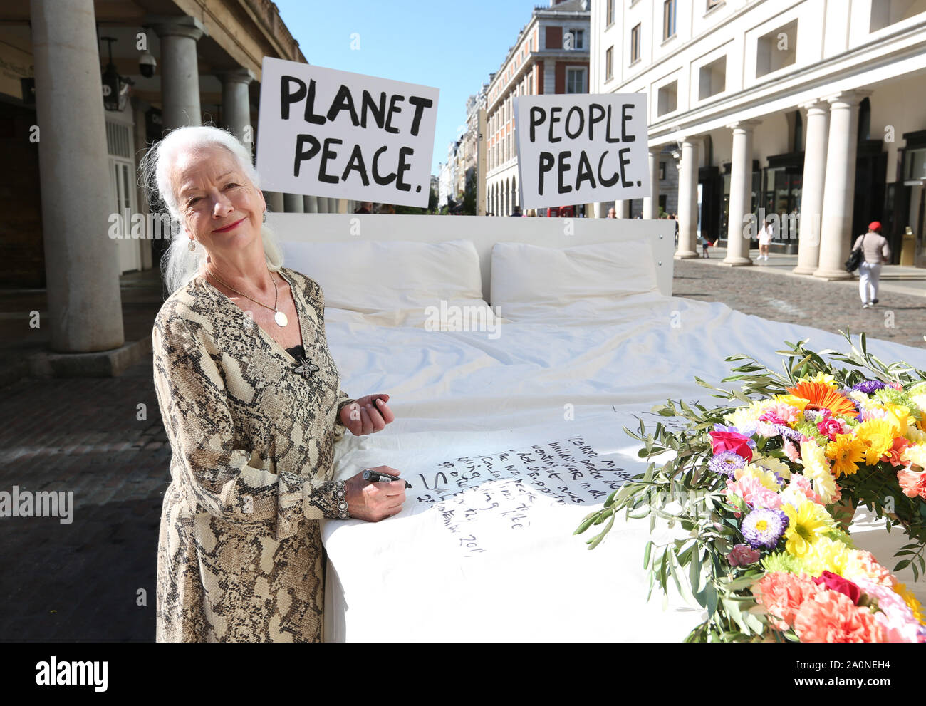 IN PHOTO - Three time Nobel Peace Prize nominee Dr Scilla Elworthy Members of the public write their very own Ôpeace pledge to the planet' onto an iconic bed installed at Covent Garden in London by ethical herbal tea company, Pukka Herbs to promote living peacefully on and protecting the planet this International Day of Peace. Stock Photo