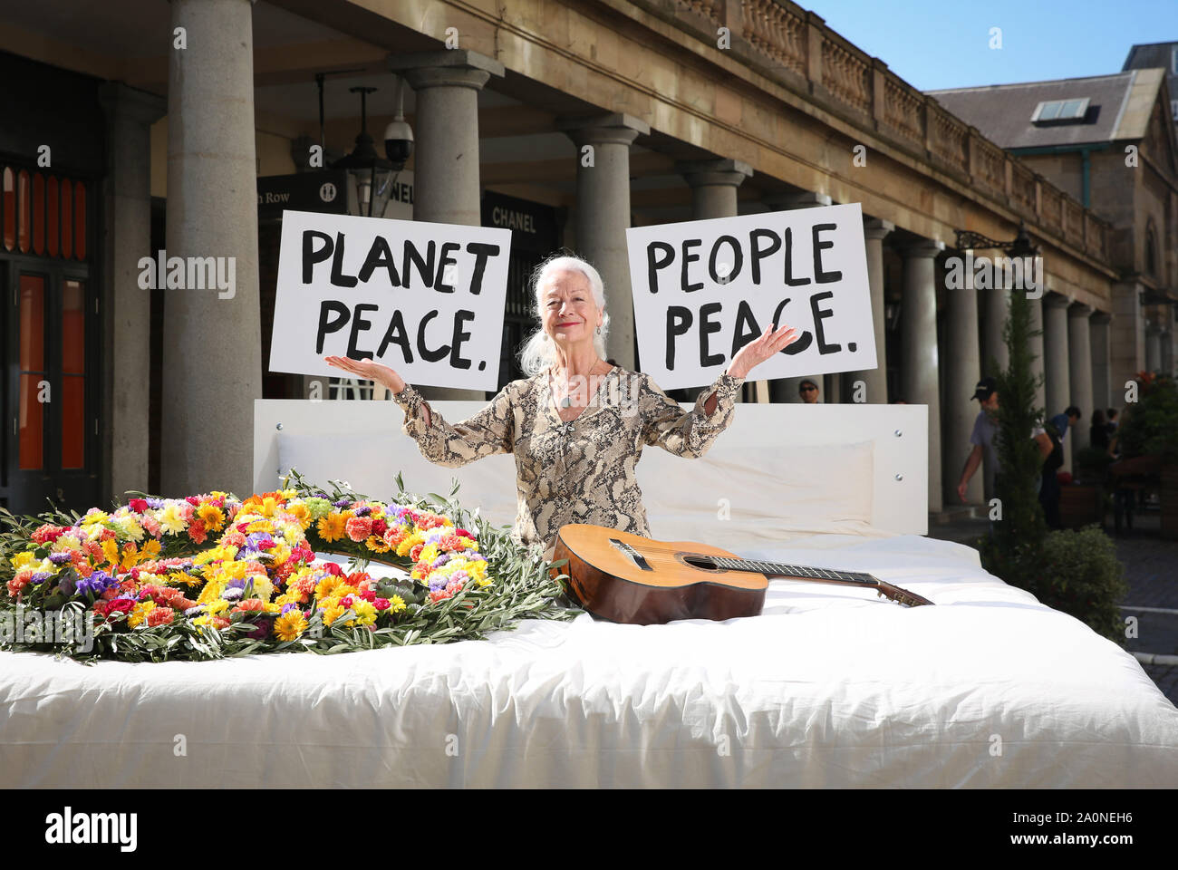 IN PHOTO - Three time Nobel Peace Prize nominee Dr Scilla Elworthy Members of the public write their very own Ôpeace pledge to the planet' onto an iconic bed installed at Covent Garden in London by ethical herbal tea company, Pukka Herbs to promote living peacefully on and protecting the planet this International Day of Peace. Stock Photo