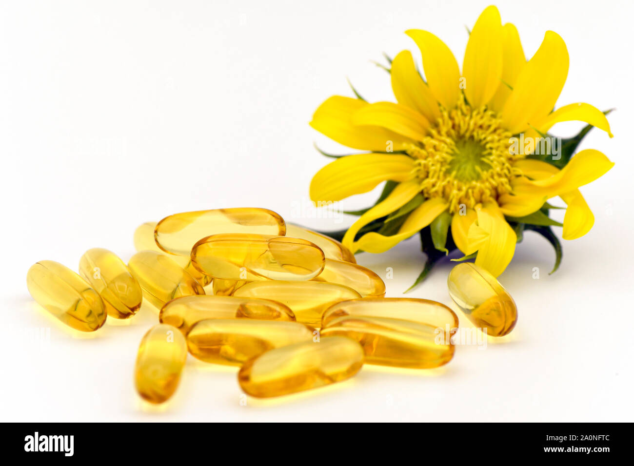 Dietary supplement capsule from natural ingredients. Essential oil from organic and natural source. Stock Photo