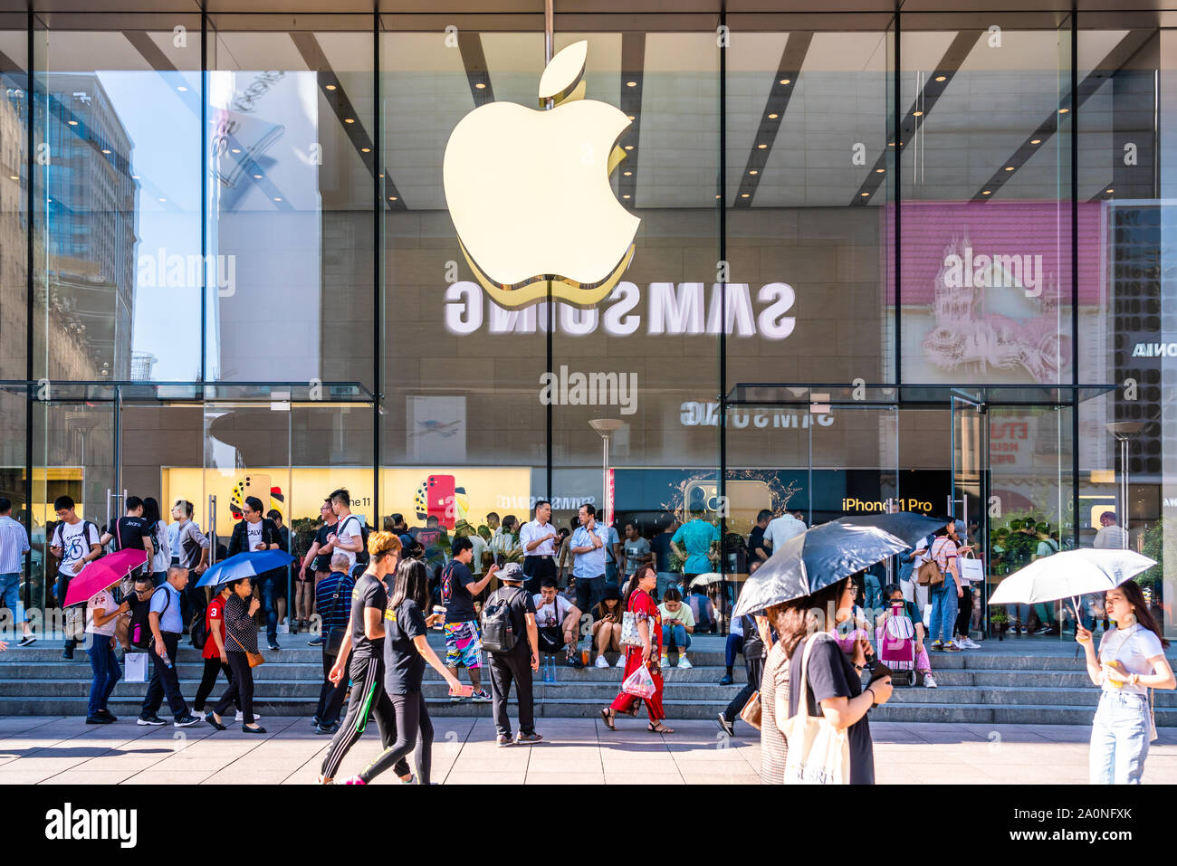 Pedestrians walk past an American multinational technology company Apple  retail store on East Nanjing Road in Shanghai.Apple launched sales of its  latest iPhone 11 series in China Stock Photo - Alamy