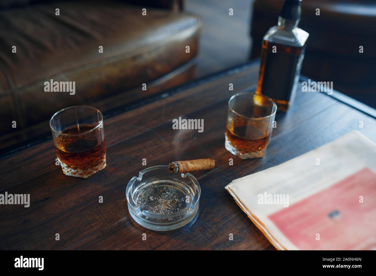 Whiskey and cigar on wooden table in retro office Stock Photo