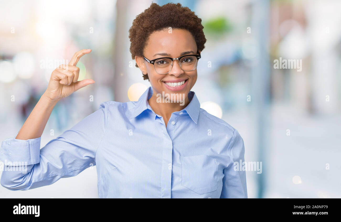 Young beautiful african american business woman over isolated ...