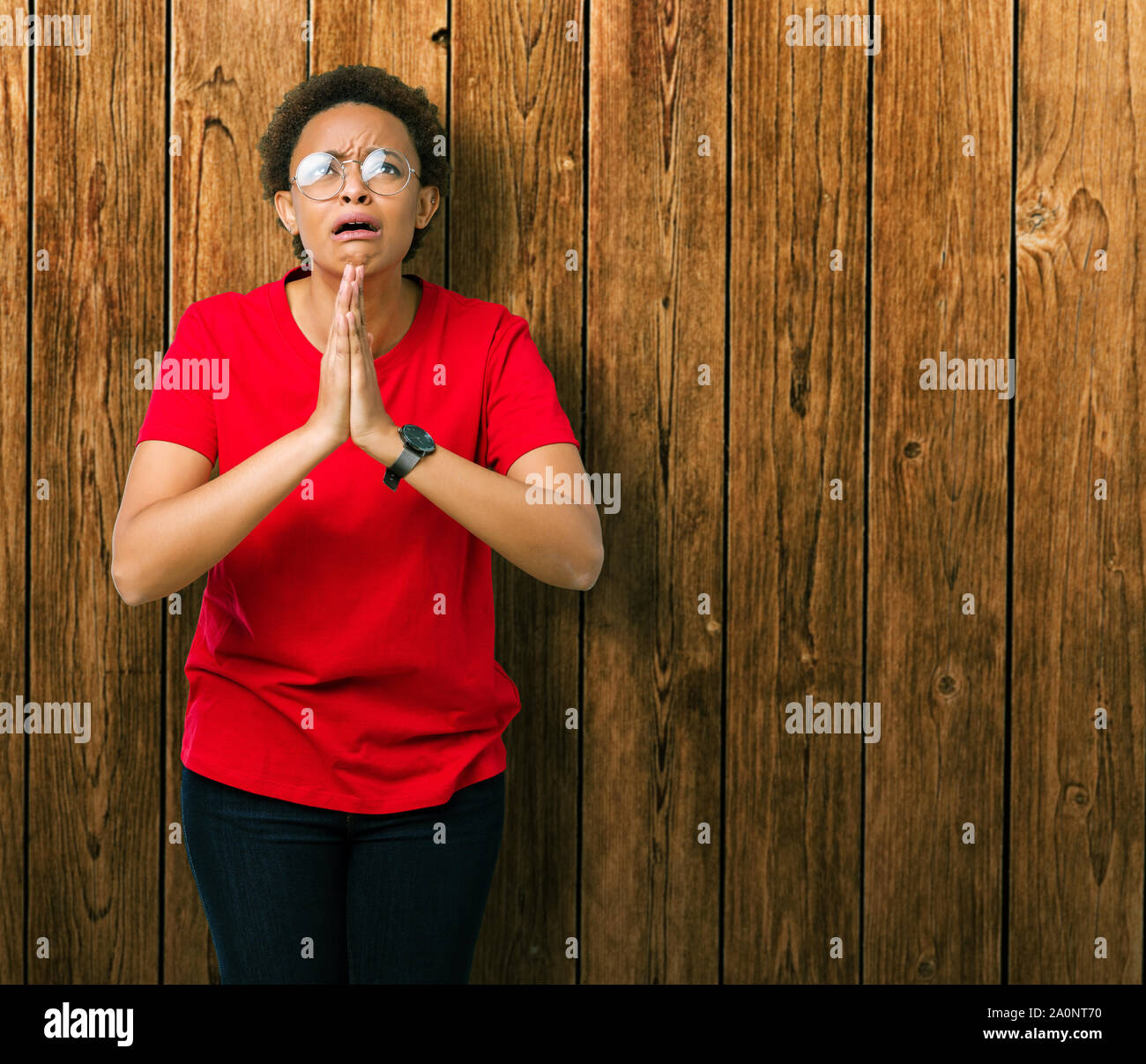 Hope Expression Beautiful young african american woman wearing glasses over isolated ...
