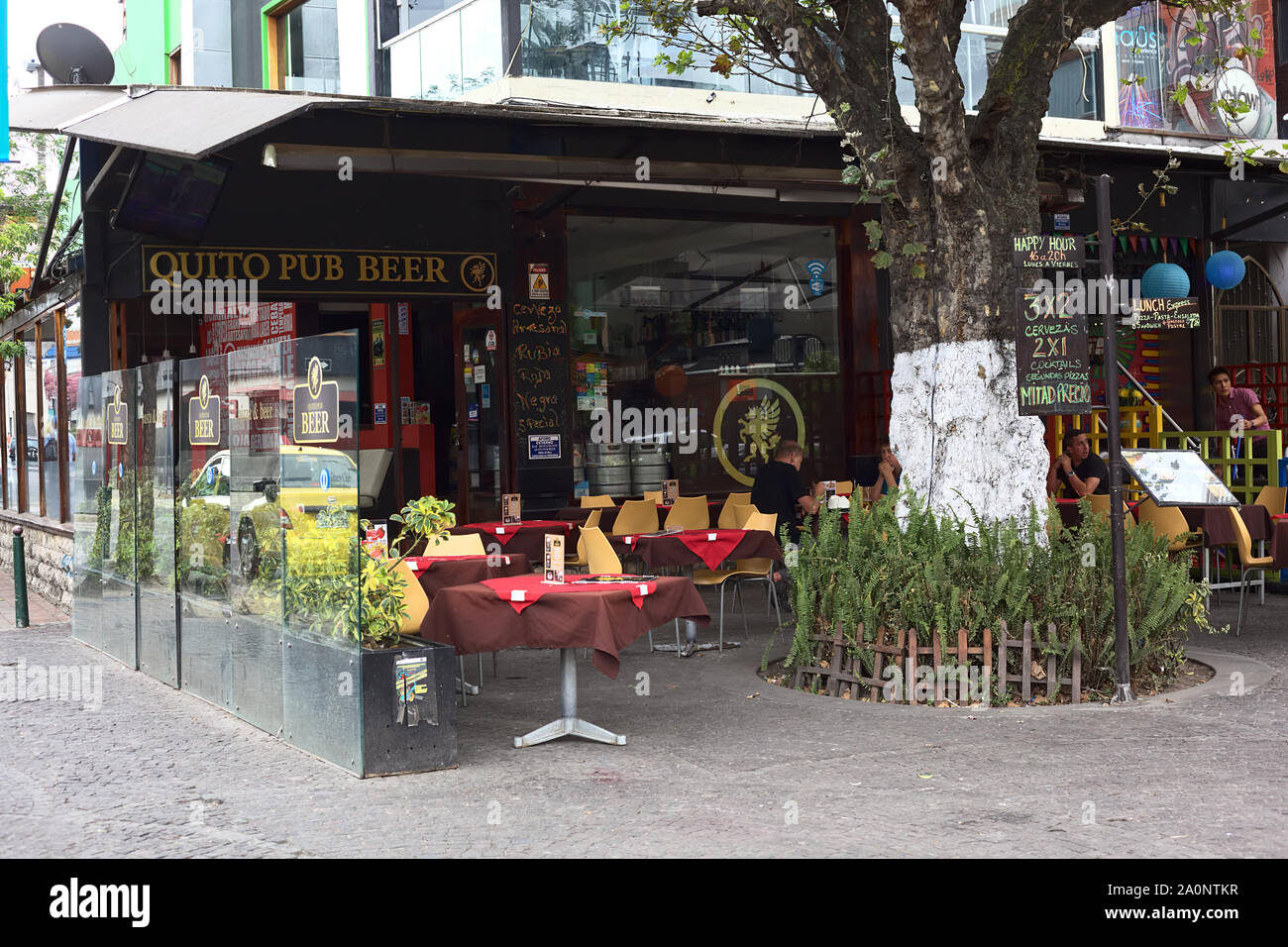 QUITO, ECUADOR - AUGUST 6, 2014: Unidentified people sitting at outdoor tables of the Quito Pub Beer on Plaza Foch in the tourist district La Mariscal Stock Photo