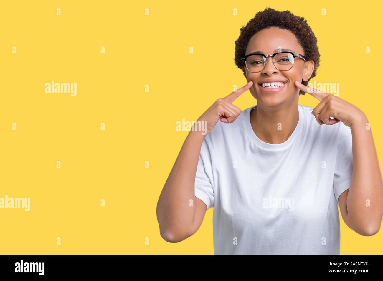 Beautiful young african american woman wearing glasses over isolated ...