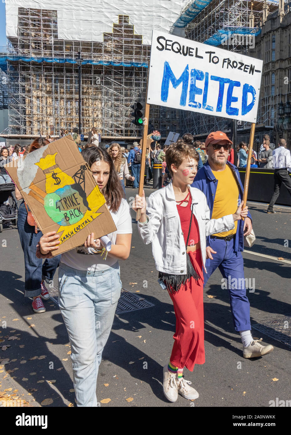 London / UK - September 20th 2019 - Young climate change activist hold signs saying Sequel To Frozen, Melted, and Strike Back at climate strike demons Stock Photo