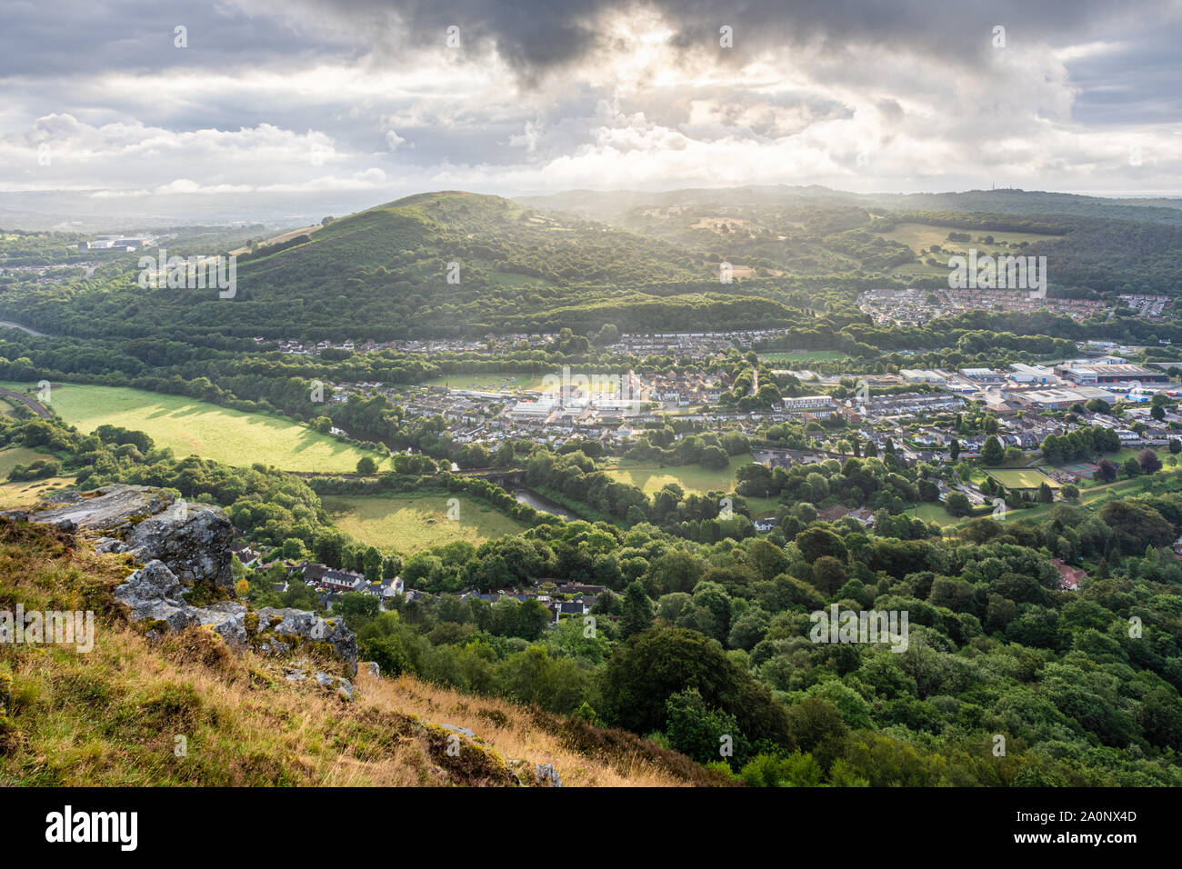 Morning light illuminates the hills and valleys of South Wales with the towns of Taff's Well and Caerphilly as seen from The Garth Mountain. Stock Photo