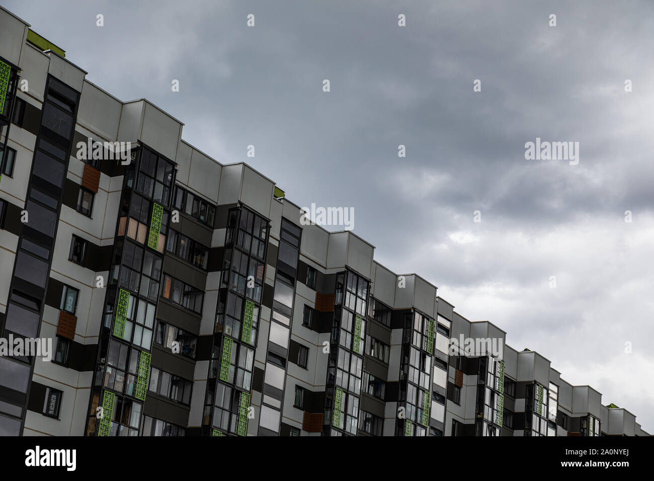 Modernly designed multiple family dwelling against gloomy sky Stock Photo