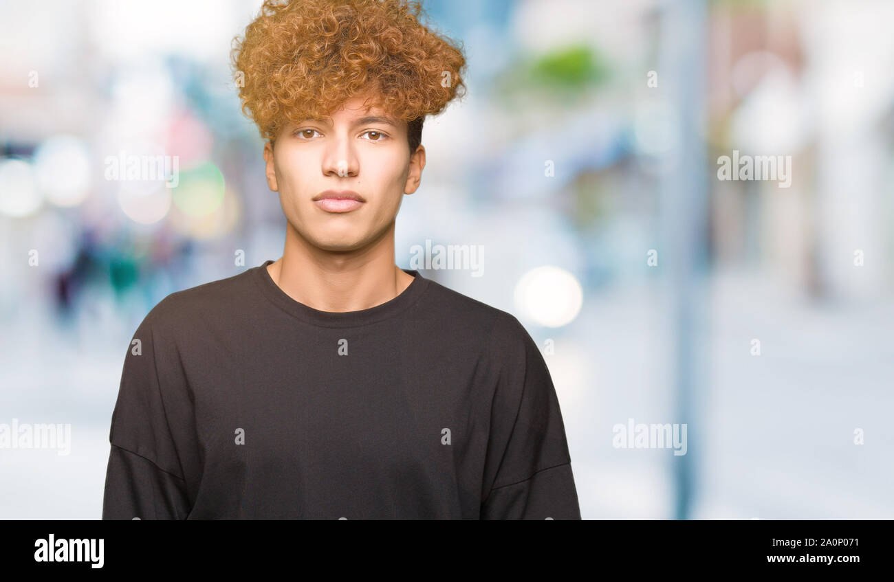 Young Handsome Man With Afro Hair Wearing Black T Shirt Relaxed