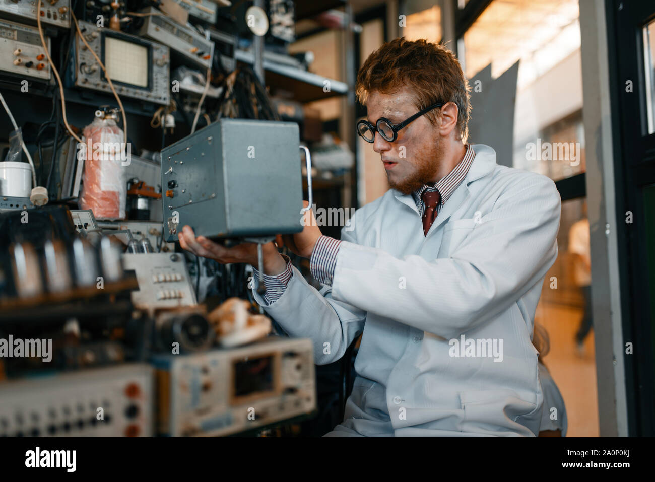 Scientist in glasses holds electrical device Stock Photo
