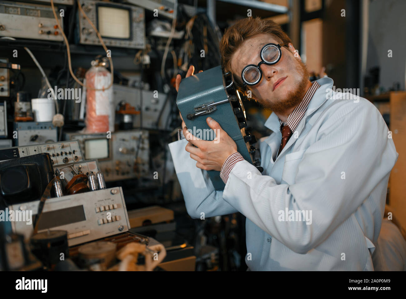 Scientist in glasses holds electrical device Stock Photo